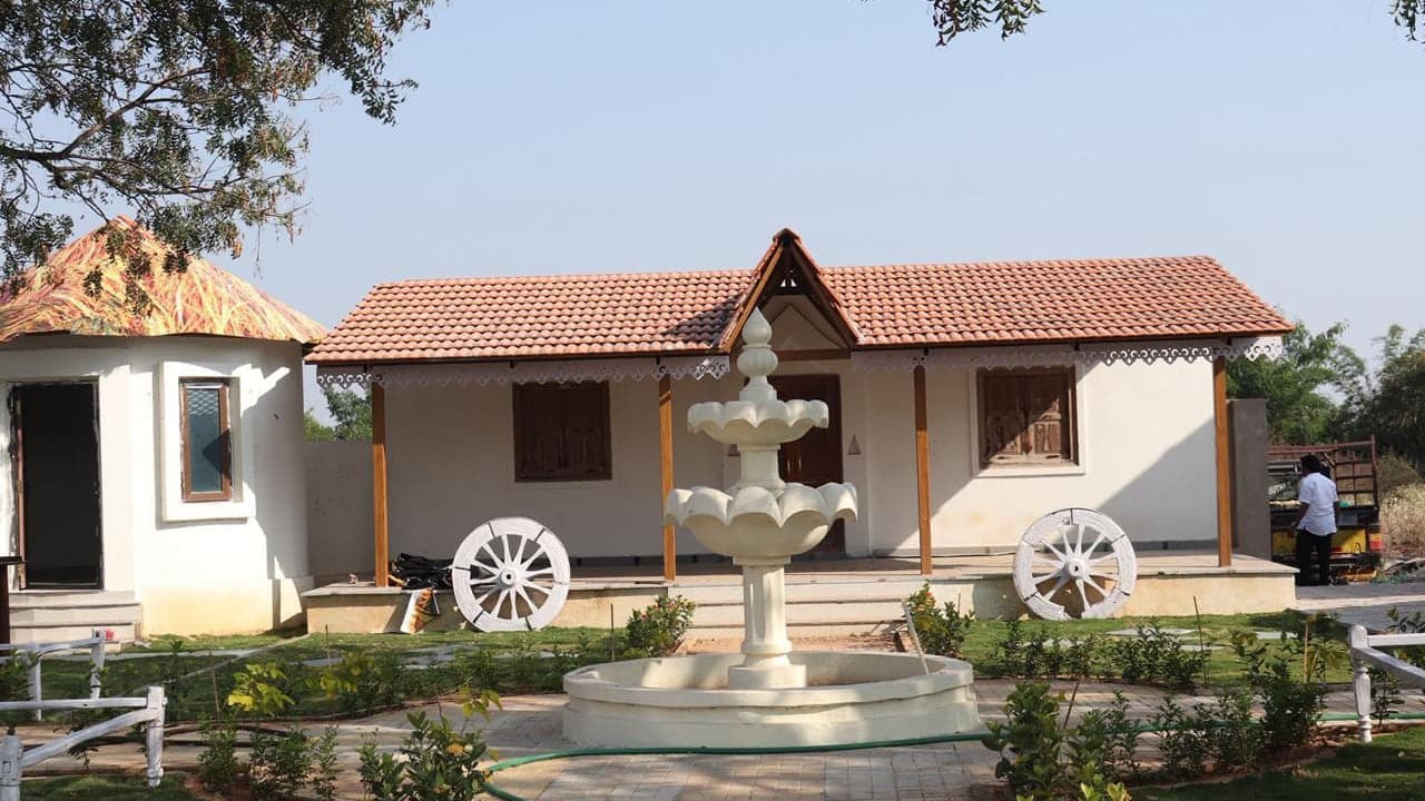 Tiled-roof cottage and open ground at Mytri Farmhouse near Kondapochamma Sagar, Siddipet