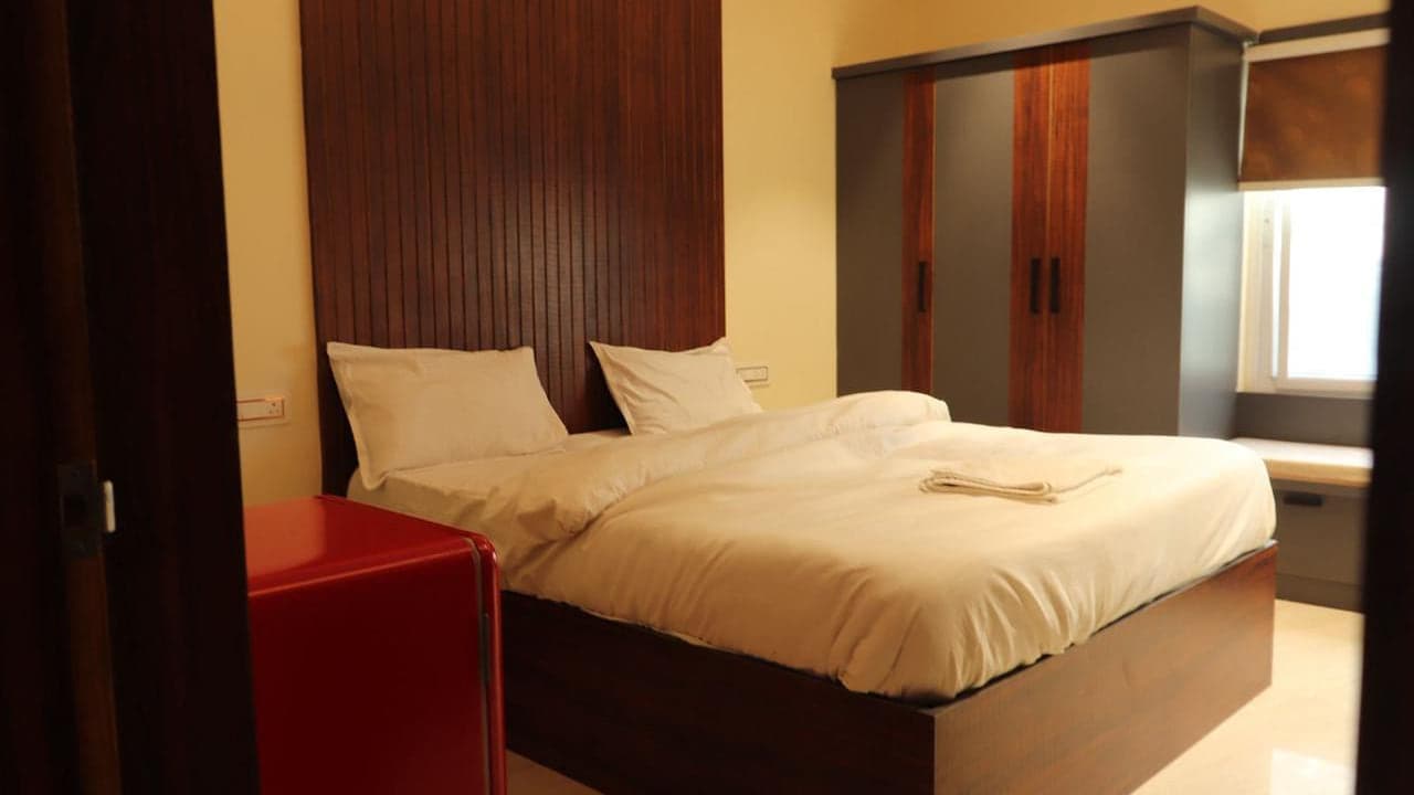 Guest room with a double bed and wardrobe at Mytri Farmhouse near Kondapochamma Sagar, Siddipet