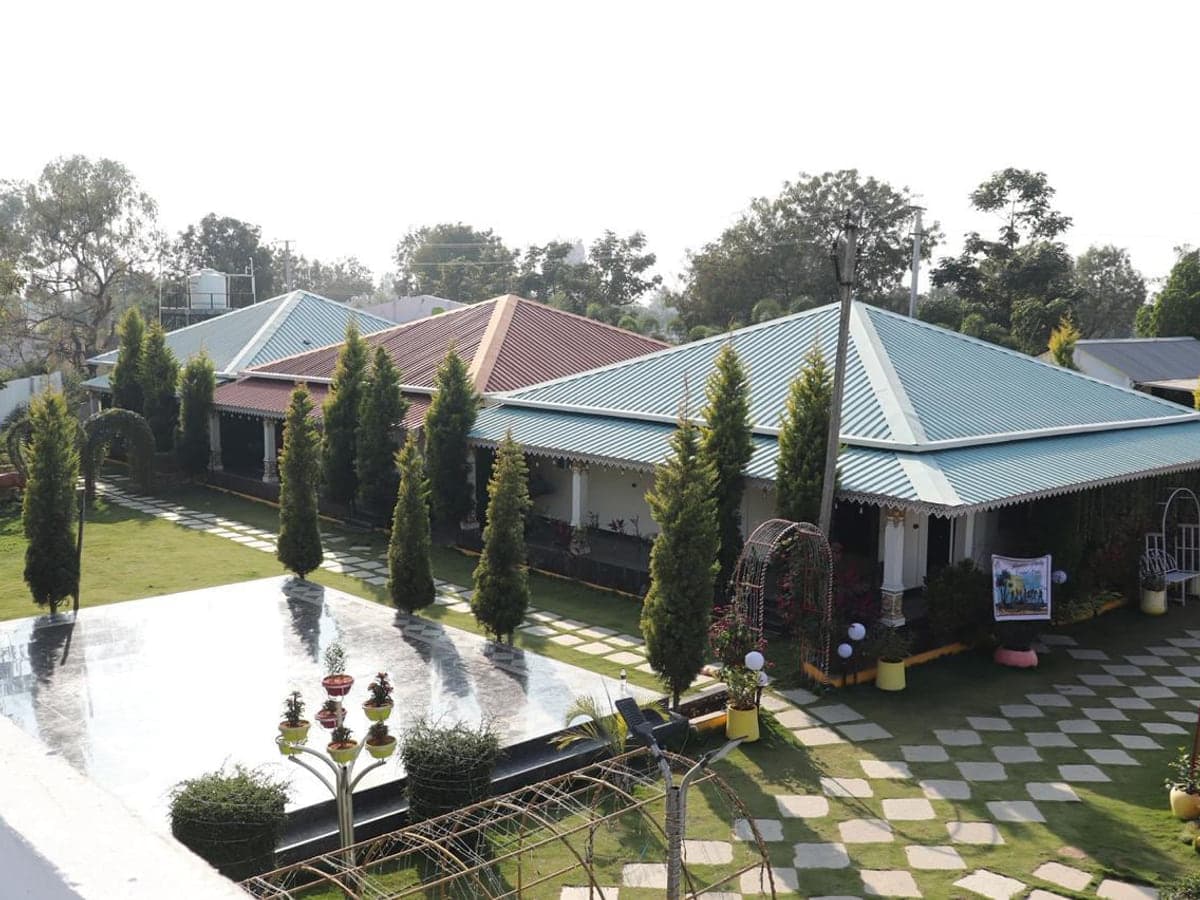 Guest room block, lawns and garden paths at Mythri Farm Stays near Kondapochamma Sagar, Siddipet